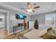 Comfortable bedroom with a ceiling fan, television, and access to an en suite bathroom and walk-in closet at 7135 Polaris Ave, Las Vegas, NV 89118