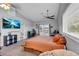 Well-lit bedroom featuring a ceiling fan, carpet, french doors to a balcony, and a modern decor at 7135 Polaris Ave, Las Vegas, NV 89118