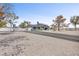 Large home exterior with long driveway and gravel yard, basketball hoop, and desert landscaping at 7135 Polaris Ave, Las Vegas, NV 89118