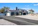 View of the home's exterior featuring solar panels and desert-style landscaping at 7135 Polaris Ave, Las Vegas, NV 89118