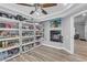 Spacious pantry with built-in shelving, a fireplace, gray walls and wood-look floors at 7135 Polaris Ave, Las Vegas, NV 89118