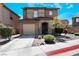 Two-story house with attached garage and neatly landscaped front yard at 1121 Paradise Desert Ave, Henderson, NV 89002