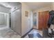 Hallway with decorative tiled floor, access to closet, and door to the outside at 2240 Horse Creek Cir, Henderson, NV 89014