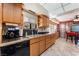 Functional kitchen featuring wooden cabinets, stainless steel sink, and modern appliances at 2240 Horse Creek Cir, Henderson, NV 89014