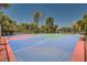 A colorful tennis court surrounded by mature trees at 750 S Royal Crest Cir # 353, Las Vegas, NV 89169