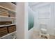 Combined image of a bathroom with a tub/shower and a shelf with neatly stacked towels at 510 Duvet Ct, Henderson, NV 89012