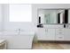 Elegant bathroom featuring a soaking tub, modern vanity, and bright natural light at 510 Duvet Ct, Henderson, NV 89012
