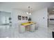 Dining area with a modern light fixture, unique table, and bright decorations at 510 Duvet Ct, Henderson, NV 89012