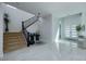 Bright foyer with a staircase, white marble floors, and contemporary design elements at 510 Duvet Ct, Henderson, NV 89012