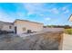 Backyard showing a detached garage with a roll up door and a window unit at 1430 Red Rock Dr, Pahrump, NV 89048