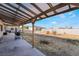 Backyard with wooden pergola and an outdoor grill in the foreground at 1430 Red Rock Dr, Pahrump, NV 89048