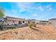 Full backyard view of a single story home with a red tiled roof at 1430 Red Rock Dr, Pahrump, NV 89048