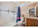 Bright bathroom featuring tiled walk-in shower, granite countertop, and decorative fixtures at 1430 Red Rock Dr, Pahrump, NV 89048