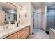 Bathroom with double sinks, ample counter space, and tiled shower at 1430 Red Rock Dr, Pahrump, NV 89048