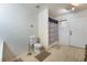 Bright bathroom featuring a shower with patterned curtain and light wood-look floors at 1430 Red Rock Dr, Pahrump, NV 89048