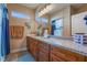 Well-lit bathroom features dual sinks, granite countertops, and wood cabinetry at 1430 Red Rock Dr, Pahrump, NV 89048