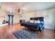 Spacious bedroom features hardwood floors, ceiling fan, and decorative fireplace at 1430 Red Rock Dr, Pahrump, NV 89048