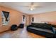 Cozy bedroom with window, door, and black futon at 1430 Red Rock Dr, Pahrump, NV 89048