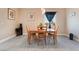 Bright dining room with a wood table, four chairs, and a window view at 1430 Red Rock Dr, Pahrump, NV 89048