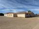 Single-story home featuring an attached two-car garage surrounded by a desert landscape at 1430 Red Rock Dr, Pahrump, NV 89048