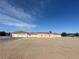 Expansive single-story home with an attached two-car garage and a sprawling landscape at 1430 Red Rock Dr, Pahrump, NV 89048