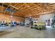 Spacious garage featuring a car lift, unfinished car and ample storage space at 1430 Red Rock Dr, Pahrump, NV 89048