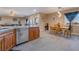 Open kitchen features granite countertop, wood cabinets, and stainless steel dishwasher at 1430 Red Rock Dr, Pahrump, NV 89048