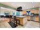 Spacious kitchen with a central island, wooden cabinets, and modern stainless steel appliances at 1430 Red Rock Dr, Pahrump, NV 89048