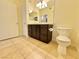 Clean bathroom with dark brown vanity, tile flooring, and shower/tub combo at 9050 W Warm Springs Rd # 1016, Las Vegas, NV 89148