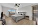 Spacious bedroom with a large bed, light gray bedding, and wood flooring at 4657 Warner Pl, Las Vegas, NV 89115