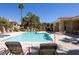 Community pool with plenty of lounge chairs for residents to relax and enjoy the sun at 1050 E Cactus Ave # 2104, Las Vegas, NV 89183