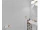Bright bathroom featuring a pedestal sink, storage shelf, and modern fixtures at 10568 Salmon Leap St, Las Vegas, NV 89183