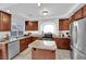 Well-lit kitchen with stainless steel appliances, granite counters, and an island at 10568 Salmon Leap St, Las Vegas, NV 89183