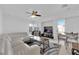 Bright living room with a white leather sofa, modern rug, and ample seating at 10568 Salmon Leap St, Las Vegas, NV 89183