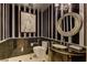 Stylish powder room with black and white striped wallpaper at 9101 Alta Dr # 902, Las Vegas, NV 89145