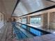 Indoor lap pool with large windows and marble flooring at 9101 Alta Dr # 902, Las Vegas, NV 89145