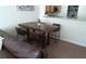 Simple dining area with a wood table and four brown leather chairs at 7135 S Durango Dr # 204, Las Vegas, NV 89113