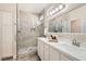 Bathroom features double sinks, a large framed mirror, and glass enclosed shower at 10315 Premia Pl, Las Vegas, NV 89135