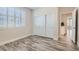 Bedroom with wood-look floors, plantation shutters and double door closet at 10315 Premia Pl, Las Vegas, NV 89135