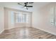 Spacious bedroom with bay windows and stylish ceiling fan at 10315 Premia Pl, Las Vegas, NV 89135