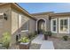 Inviting front entrance with beautiful succulent landscaping and an arched doorway at 10315 Premia Pl, Las Vegas, NV 89135