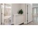 Hallway with view into bathroom; note cabinet for storage in hallway and consistent flooring at 10315 Premia Pl, Las Vegas, NV 89135