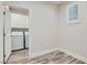 Open laundry room with window, cabinets, and modern appliances with open door to kitchen at 10315 Premia Pl, Las Vegas, NV 89135