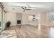 Open-concept living area showcasing a fireplace, ceiling fan and adjacent kitchen at 10315 Premia Pl, Las Vegas, NV 89135