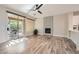 Bright living room featuring hardwood floors, fireplace, and access to the outdoor patio at 10315 Premia Pl, Las Vegas, NV 89135