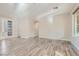 Bright living area with hardwood floors, archway, and a decorative front door at 10315 Premia Pl, Las Vegas, NV 89135