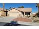 Single-story house with a two-car garage and well-maintained landscaping at 5034 Sail Rock Pl, North Las Vegas, NV 89031