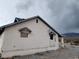 Exterior view of a home with siding, a satellite dish, and boarded up windows at 4780 Horizon Ave, Pahrump, NV 89060