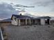 Exterior view of a single-story home with stucco walls and boarded windows at 4780 Horizon Ave, Pahrump, NV 89060