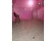 Unique pink room featuring tile flooring, a bar stool, and vintage chandelier at 4780 Horizon Ave, Pahrump, NV 89060